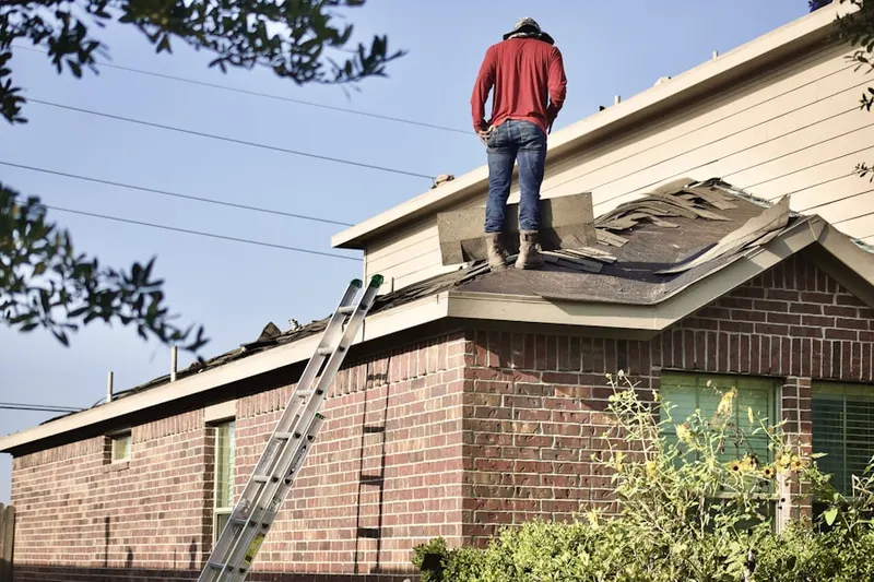 Professional roofer working on a residential roof in Rose Lake